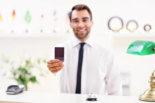 Happy receptionist working in hotel photo