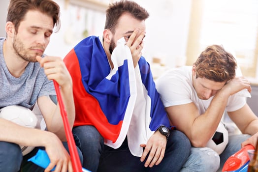 Happy male friends cheering and watching sports on tv photo