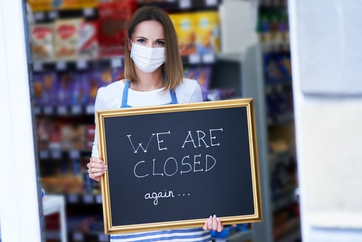 Shop assistant holding announcement board photo