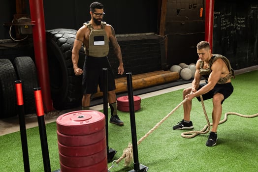 Sled drag exercise. Sportsman during his cross training workout. photo