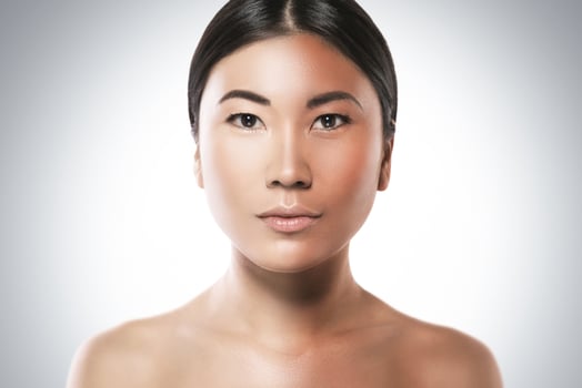 Difference in skin brightness. Concept of facial whitening or sun protection. photo