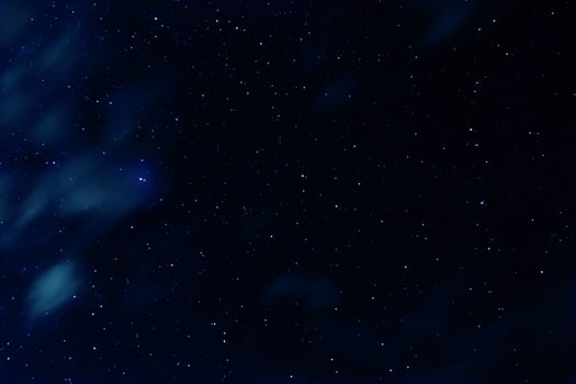 Night sky with stars and clouds in motion photo