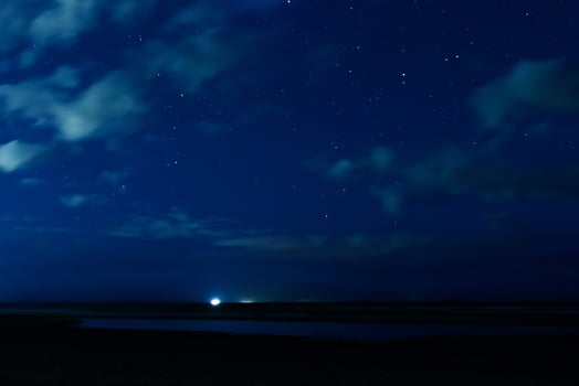 Night sky with stars and clouds in motion photo