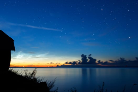 Night sky with stars and clouds in motion photo