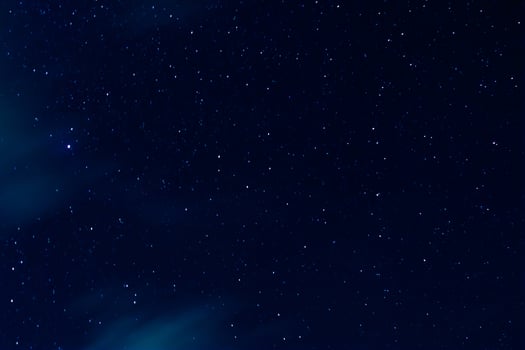 Night sky with stars and clouds in motion photo