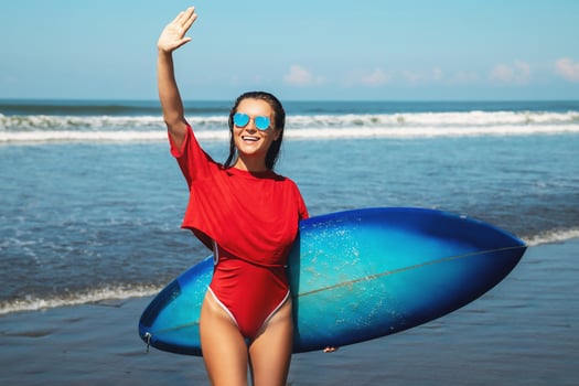 Sexy woman surfer with shortboard on the beach photo