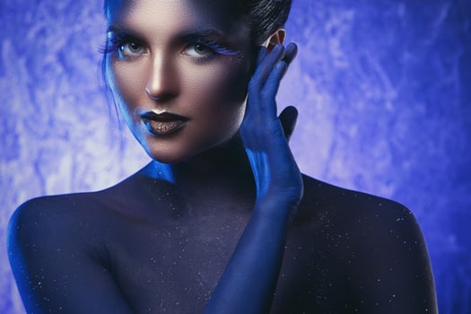 Beautiful woman with a creative makeup and body-art photo