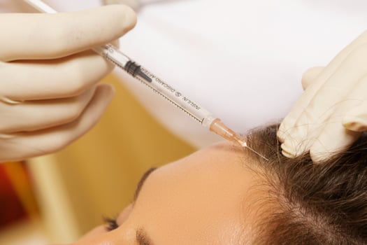 Woman getting special injection for hair growth photo