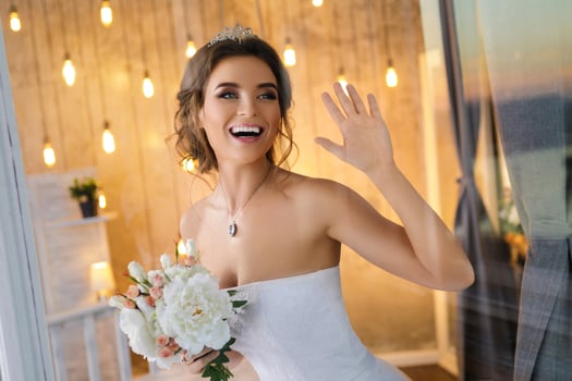 Happy and beautiful bride with bouquet of flowers photo