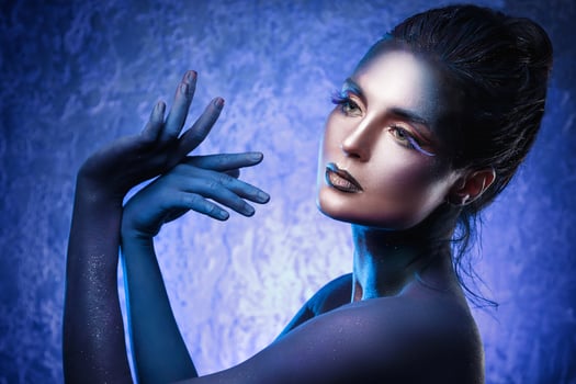 Beautiful woman with a creative makeup and body-art photo