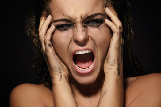 Beautiful woman with smudged makeup on her face photo