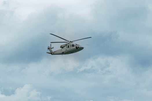 Military gray navy helicopter flying in the sky photo