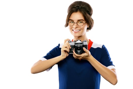 Woman model in vintage look holding retro camera in her hands photo