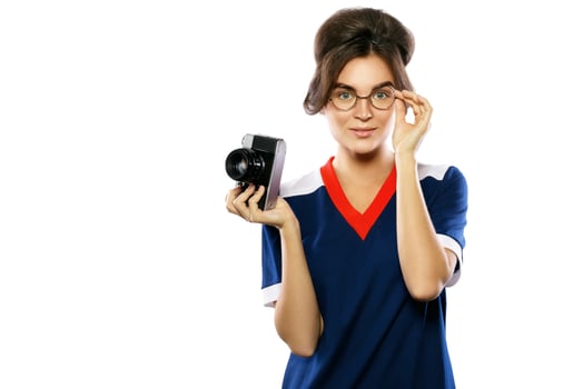 Woman model in vintage look holding retro camera in her hands photo