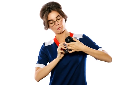 Woman model in vintage look holding retro camera in her hands photo