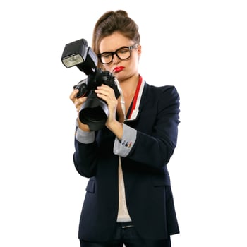 Woman photographer with a DSLR camera on white background photo