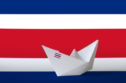 Costa Rica flag depicted on paper origami ship closeup. Handmade arts concept photo