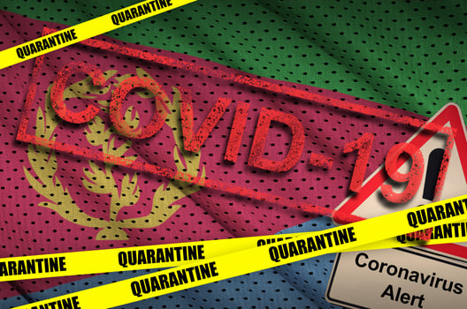 Eritrea flag and Covid-19 quarantine yellow tape with red stamp. Coronavirus or 2019-nCov virus photo