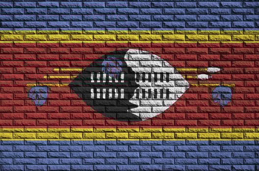 Swaziland flag is painted onto an old brick wall photo