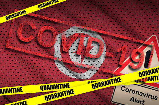 Tunisia flag and Covid-19 quarantine yellow tape with red stamp. Coronavirus or 2019-nCov virus photo