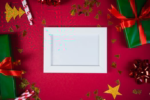 New Year and Christmas decorations on red background, flat lay. Concept of greeting card for holidays photo
