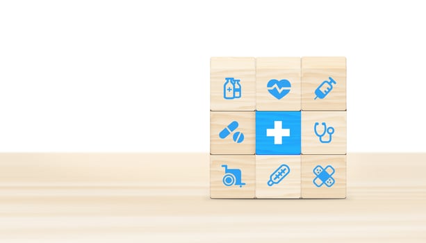 Health insurance concept, wooden blocks with healthcare medical icons on blue background, copy space. 3D illustration. photo