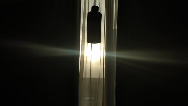 dark hotel room with yellow bulb light photo