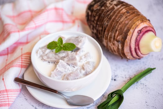 Taro food with dessert taro boiled with sugar and coconut milk on bowl and fresh raw organic taro root ready to cook, Asian Thai food photo
