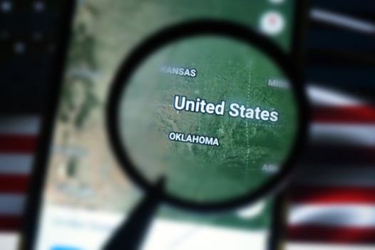 United states Of America on google maps under magnifying glass with united states of america flag  Background. photo