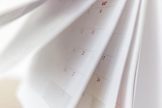 Calendar page flipping sheet close up blur background business schedule planning appointment meeting concept photo