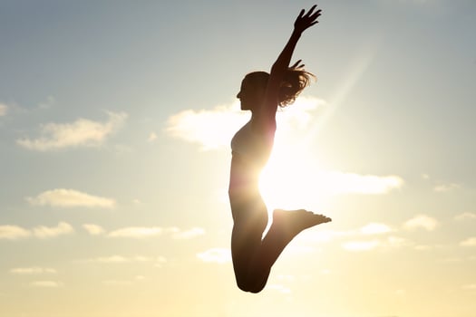 Silhouette young woman practicing yoga on the beach at sunset photo