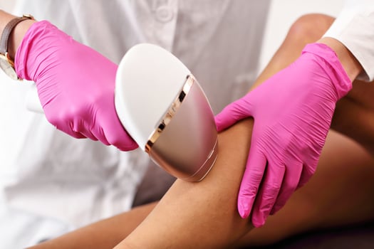 Adult woman having laser hair removal in professional beauty salon photo