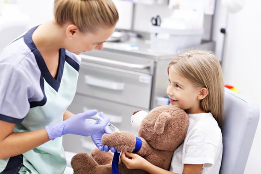 Brave little girl having blood collection for tests photo
