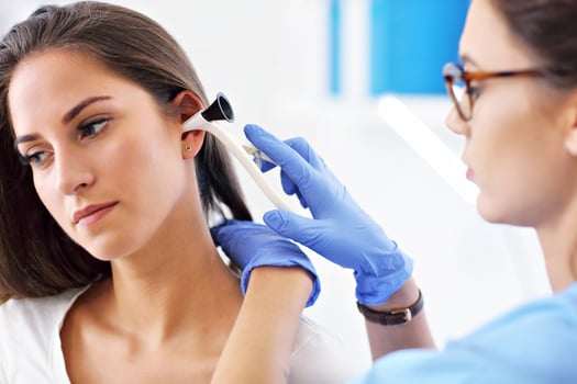 Adult woman having a visit at female laryngologist's office photo