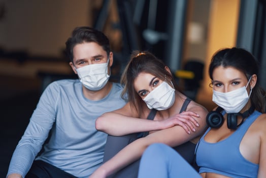 Group of people wearing masks working out in a gym photo