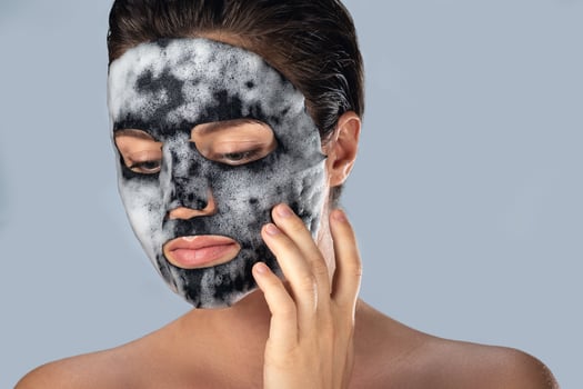 Woman with bubble sheet mask on her face photo