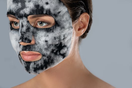 Woman with bubble sheet mask on her face photo