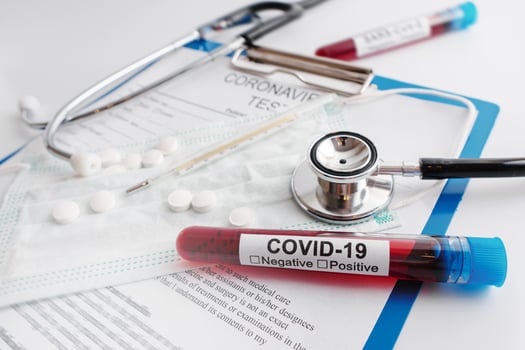 Closeup of blood sample, stethoscope and thermometer photo
