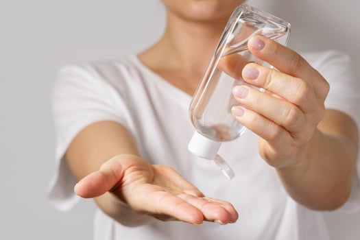 Woman with a small bottle of hand sanitizer photo
