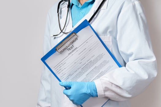 Doctor holding folder with a coronavirus test form photo