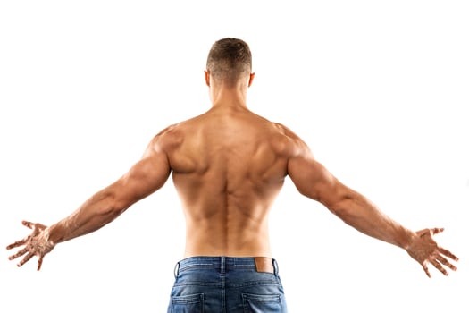 Young man showing his muscular back on white background photo