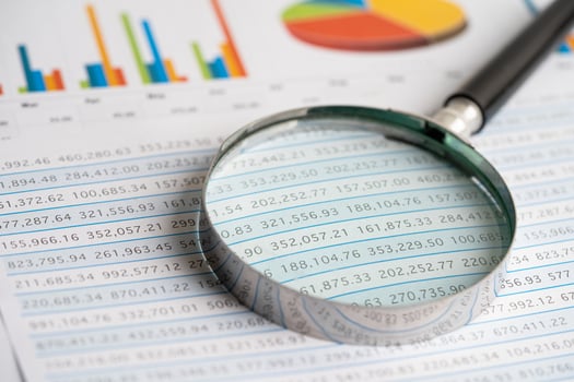 Magnifying glass on charts graphs paper. Financial development, Banking Account, Statistics, Investment Analytic research data economy, Stock exchange trading, Business office concept. photo