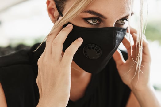 Young athletic woman wearing a prevention face mask during her fitness workout. photo