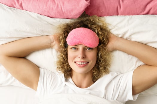 Beautiful woman with curly hair waking up after good sleep photo