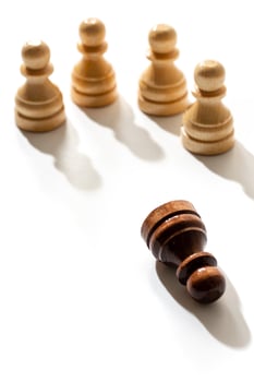 One black chess pawn among whites. Concept of racism and discrimination. photo