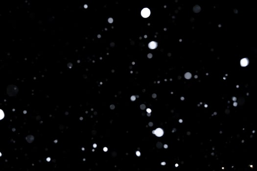 Element for winter design or overlay. Real snow over black background. photo