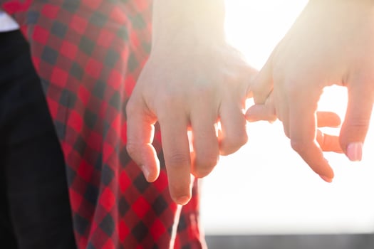 Couple holding hands with a pinky grip photo