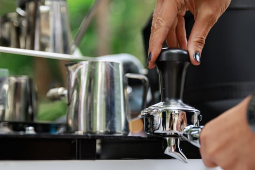 Close up of barista female hands making a coffee photo
