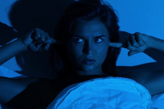 Woman with insomnia because of loud noises photo