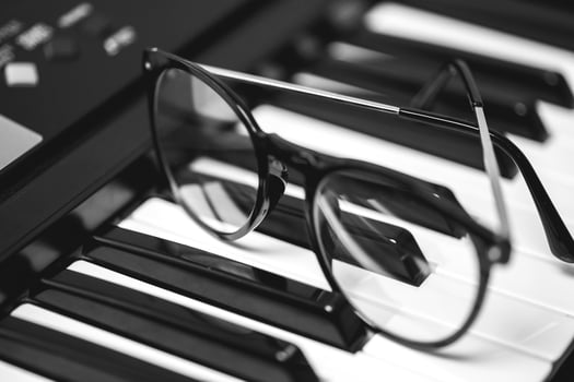 Closeup of eyeglasses on the synthesizer keyboard photo
